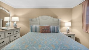 A bedroom with a bed, two bedside tables, a dresser, and a mirror. - 🌴 Winter Deal ❄️ Golf Cart-Heated Pool-FAB Reno- Seascape 22A🌊 (Miramar Beach)