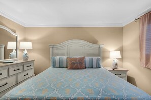 A bedroom with a bed, two bedside tables, a dresser, and a mirror. - 🌴 Winter Deal ❄️ Golf Cart-Heated Pool-FAB Reno- Seascape 22A🌊 (Miramar Beach)