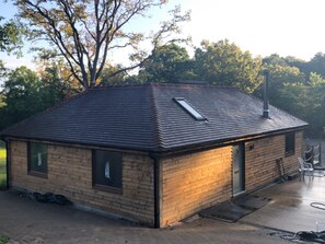 A small brick building with a sloped roof, a window, and a door. - Cottage With Heated Indoor Pool Tennis Court- 2142 (Farnham)