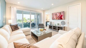 A modern living room with a sofa set, a coffee table, and a TV.