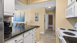 A kitchen with a built-in stove, a Keurig coffee maker, and a countertop.