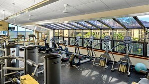 A gym with treadmills, elliptical machines, and weight equipment. - Summer Deal Oceanfront Poipu Condo with Heated Pool and Lanai (Koloa)