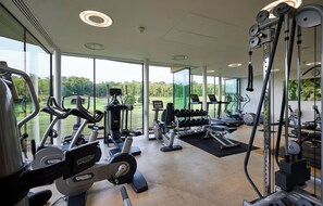 A gym with cardio machines, free weights, and a view of the outdoors. - Bowood Hotel Spa and Golf Resort (Calne)