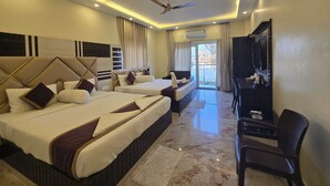 A hotel room with two beds, a ceiling fan, a TV, and a view of the outside. - Elegant Beach Resort (Kanthi)