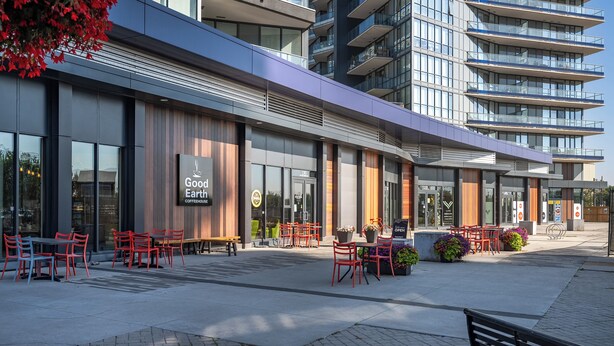A modern building with a coffeehouse named "Good Earth Coffeehouse" on the ground floor. - Spacious Riverfront DT Condo: 3 Beds, AC, Heated Parking, Stampede & Saddledome (Calgary)