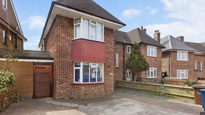 A residential building with a brick facade, a red front section, and a visible window. - South Harrow (Harrow)