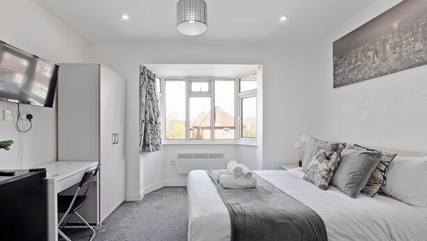 A modern bedroom with a bed, desk, and a large window. - South Harrow (Harrow)