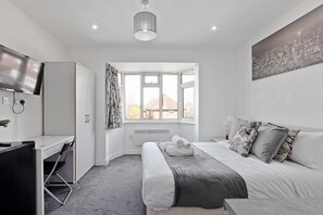 A modern bedroom with a bed, desk, and a large window. - South Harrow  (Harrow)