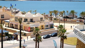 A coastal town with a marina, a lighthouse, and a beachfront promenade. - 43 (Portimão)