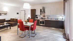 A modern apartment with a living area, dining space, and kitchen. - Suite 2 (Casamassima)
