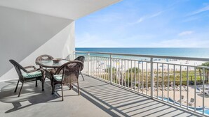 A balcony with wicker furniture and a view of the beach. - Palacio 303 (Pensacola)