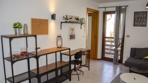 A compact living space with a kitchenette, a dining area, and a seating area.