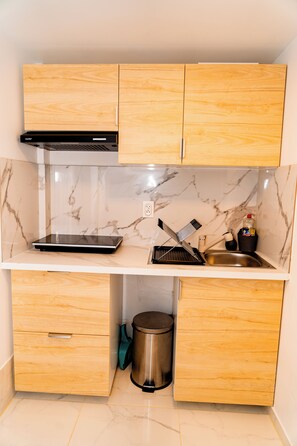 Fridge, microwave, coffee/tea maker, cookware/dishes/utensils