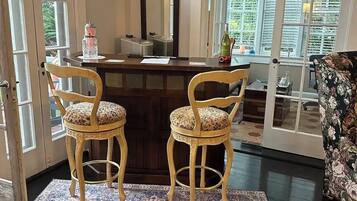 Relax in this inviting space with a comfortable desk area and plush chairs.
