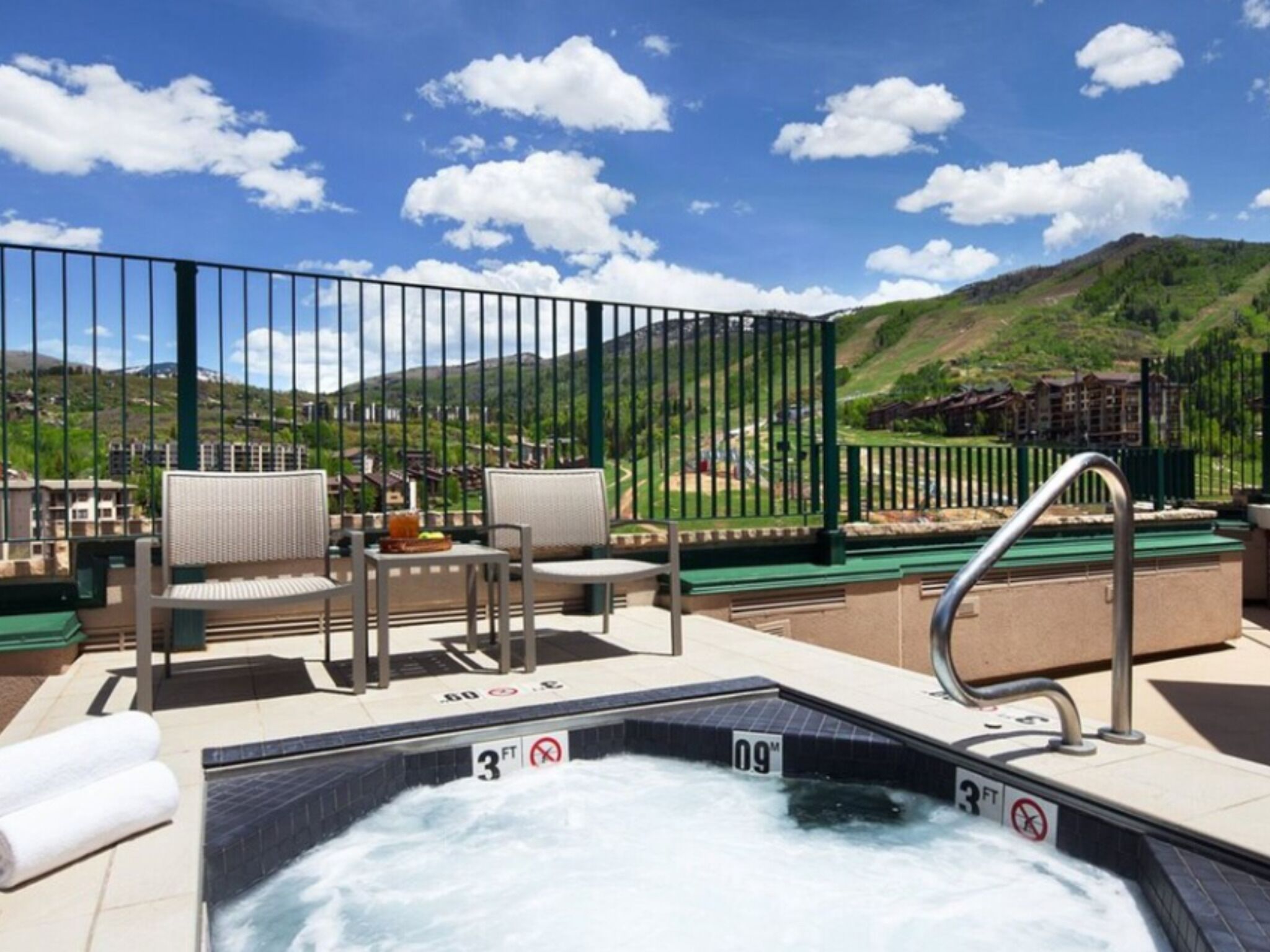 A hot tub with a view of a mountainous landscape.