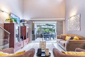 TV, fireplace - Beachside Escape in Ballito: Pizza Oven, Pool, Back - Up Power (Dolphin Coast)