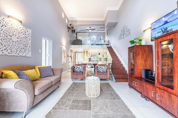TV, fireplace - Beachside Escape in Ballito: Pizza Oven, Pool, Back - Up Power (Dolphin Coast)
