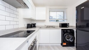 A modern kitchen with a built-in oven, microwave, and dishwasher.