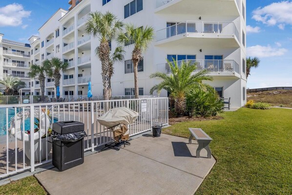 A multi-story hotel with balconies, a pool, and outdoor seating. - Palm Beach D52 (Orange Beach)
