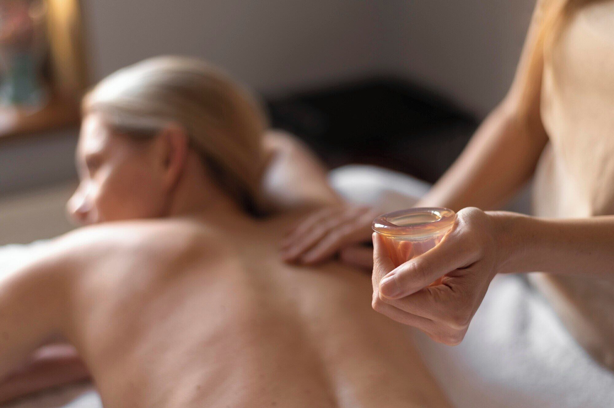 A person receiving a massage with a focus on the hands applying pressure.