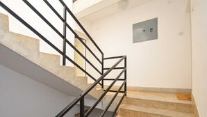 Eine Treppe mit Metallgeländer und beigefarbenen Stufen.