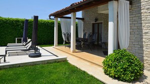 A stone building with a covered patio, outdoor seating, and a well-maintained lawn. - Sophisticated and Chic Villa with Pool - Four Bedroom Villa with Pool (Kanfanar)