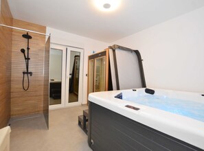 Relax in a spacious bathroom with a jacuzzi tub and separate shower area.