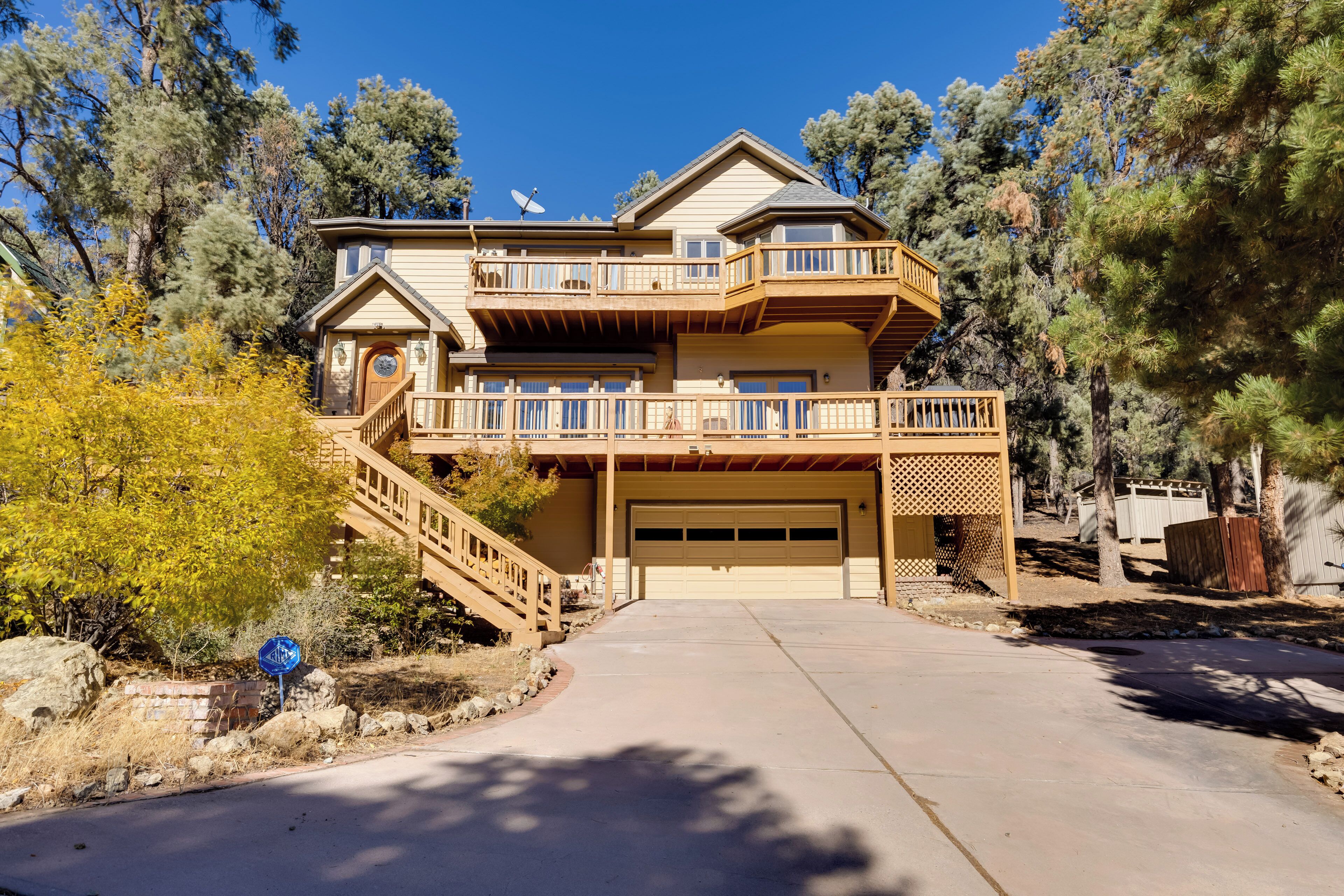 A two-story house with a garage, a balcony, and a staircase leading to the upper level.