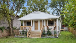 A single-story house with a front porch, wooden steps, and a small garden area. - Vibey 2-bedroom unit in duplex in Nashville (Madison)