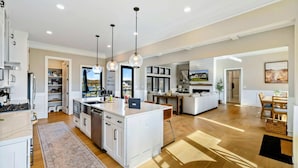 A spacious kitchen with a central island, pendant lighting, and a view to the living area. - Lakefront Lake Anna, Pool, Beach, Dock (Mineral)