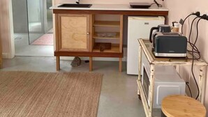 A compact kitchen with a sink, wooden cabinets, a small refrigerator, and a toaster on a cart. - Adorable 1br apt walking distance to Mullumbimby (Mullumbimby)