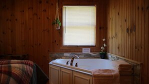 A wooden cabin bathroom with a sink, vanity, and a window with blinds. - Deer Meadow-Devil`s Bathtub/Natural Tunnel (Duffield)