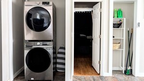 A laundry room with stacked washers and dryers, a dark room beyond, and a storage area with cleaning supplies. - New Modern 2 BR in Excellent Location (201) (Maryville)