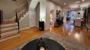 A spacious living area with a staircase, a dining area, and a kitchen.