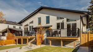 A modern two-story house with a covered patio and a small garden. - Brand New Perfect Family Home, w/ Garage Parking (Calgary)