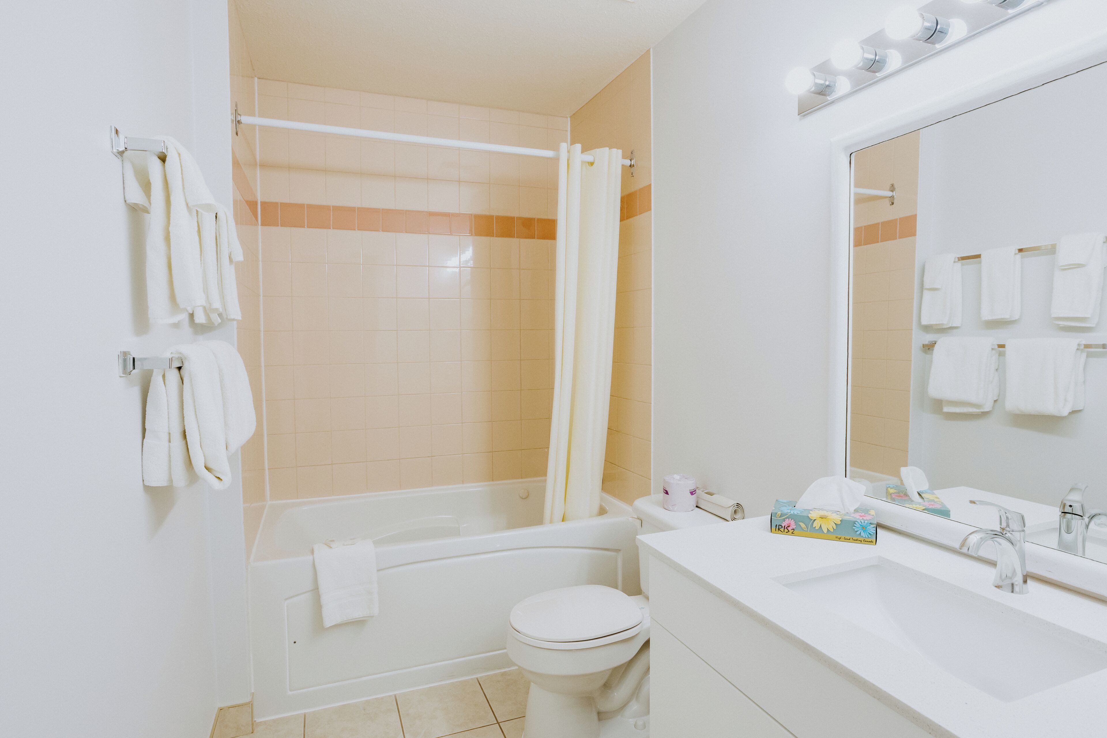 A bathroom with a bathtub, toilet, and sink.
