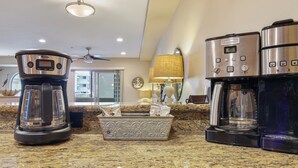 A kitchen with a coffee maker, a tea maker, and a coffee machine on a granite countertop. - Just Beachy: a charming townhome steps from Beach & Boardwalk in Pacific Beach! (San Diego)
