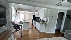 A spacious kitchen with white cabinets, a wooden countertop, and a ceiling fan. -  4-bedroom house / 2 suite. Total 3 amazing  bathrooms Marietta with AC, WiFi (Marietta)