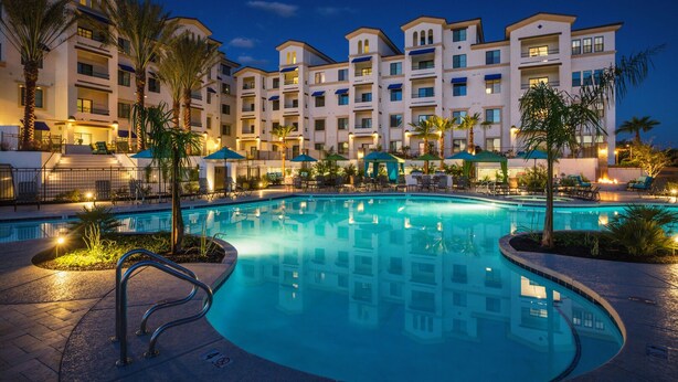 A hotel with a swimming pool surrounded by palm trees and lounge chairs. - Stay longer, Spend Less, 2 Master Suites! The Cays (Chandler)