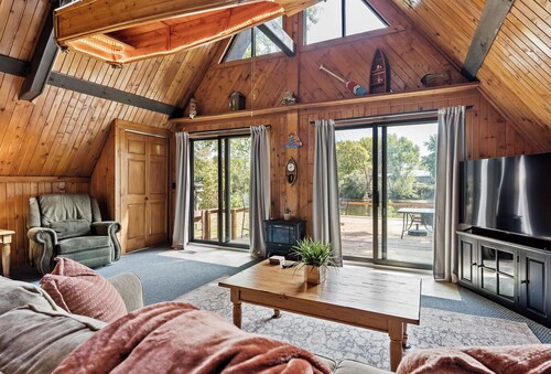 adorable A-frame house nestled right by the river
