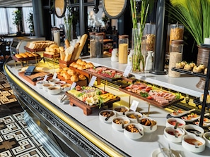 A buffet with various food items and condiments. - The Legend Hanoi Hotel (Hanoi)