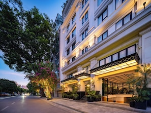 A hotel with a classic facade, multiple floors, and a well-lit entrance. - The Legend Hanoi Hotel (Hanoi)