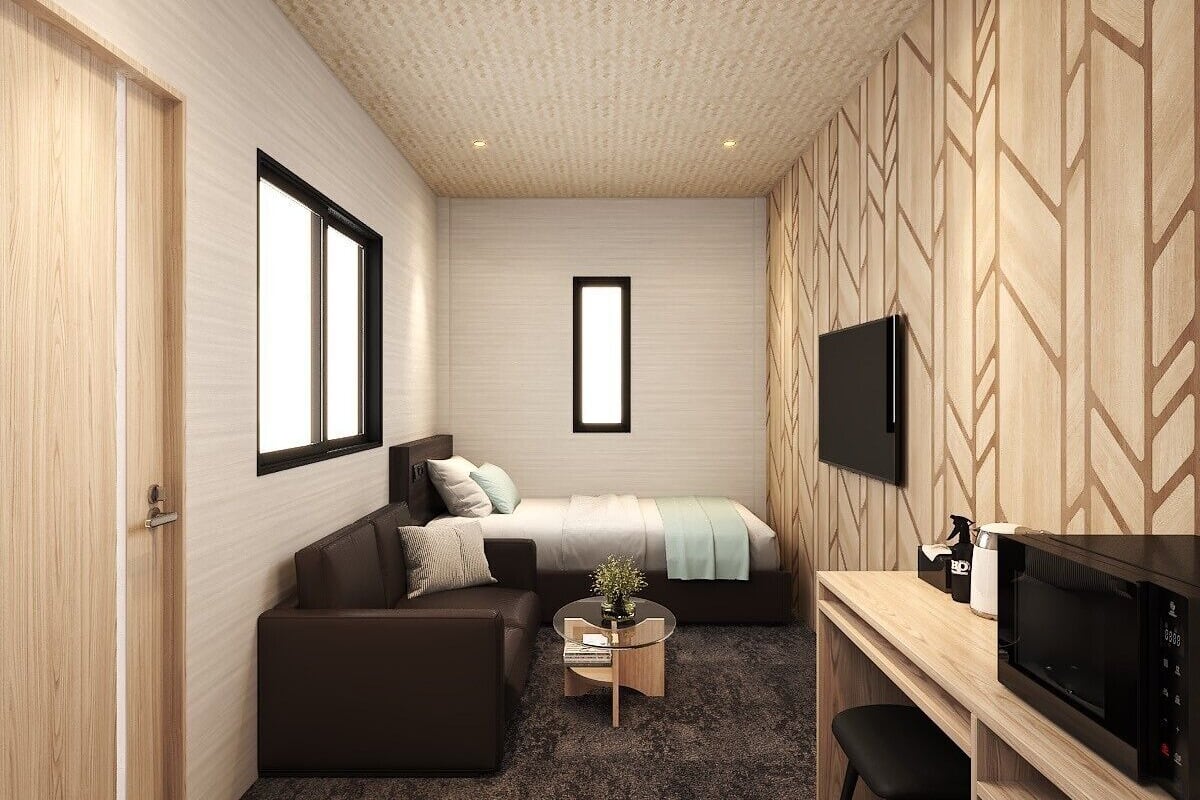 Un dormitorio moderno con cama, sofá, escritorio y televisor.