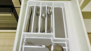 A kitchen drawer with utensils neatly organized.