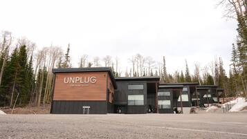 The Unplug entrance and cabin row in early spring.