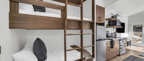 Three twin mattresses in the hallway triple bunk.
