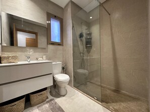 Shower, hair dryer, towels, toilet paper