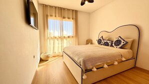A bedroom with a bed, curtains, a bedside lamp, and a window. - Marrakech Prestigia Piscine Golf Saphir (Marrakech)