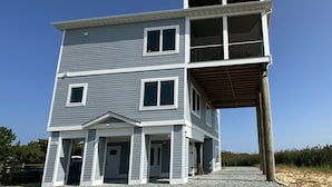 A two-story house with a balcony on the upper floor.