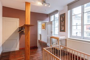 Enjoy a spacious room with a high ceiling, large window, and comfortable amenities.